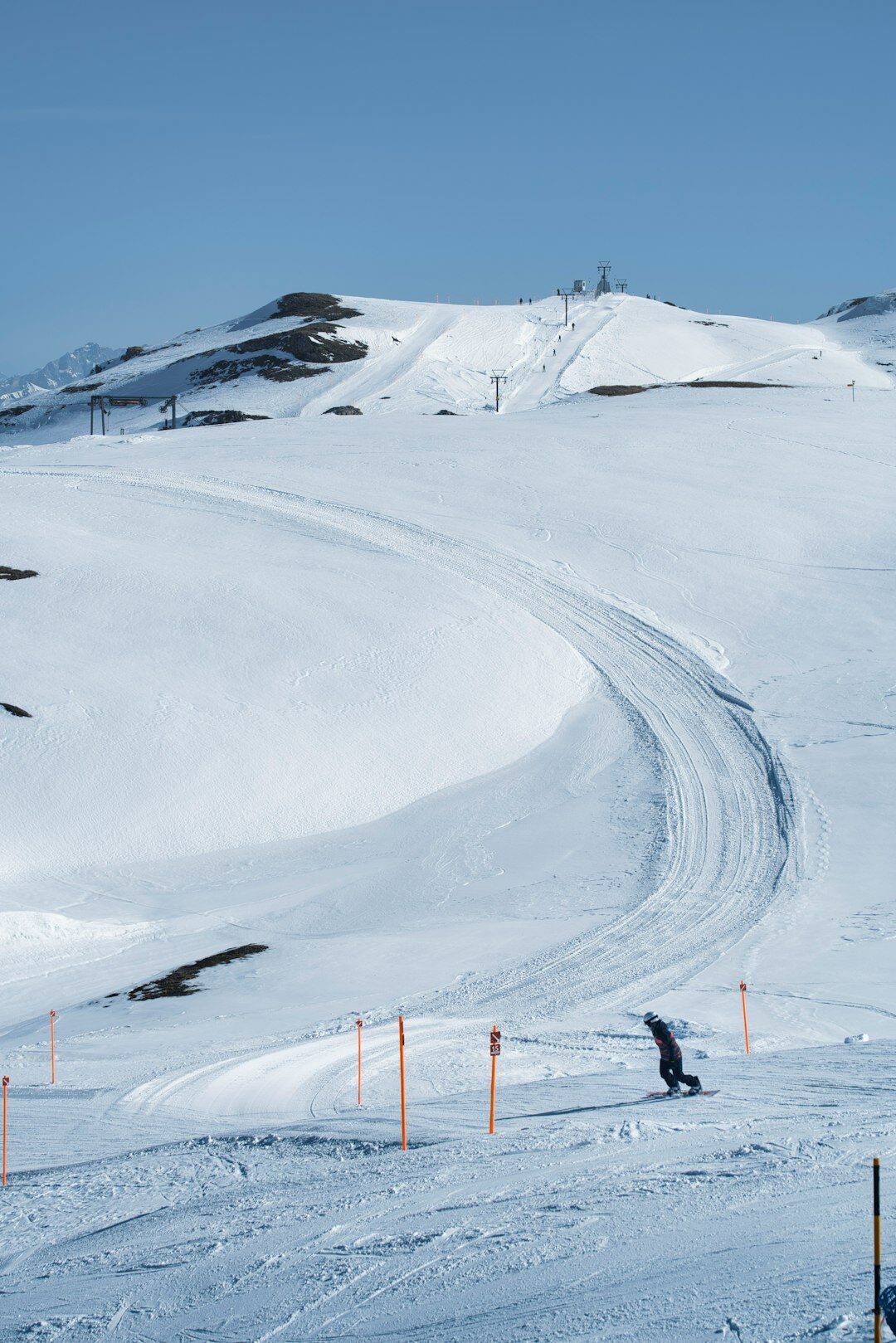Skiers descending a snow-covered slope in a Swiss alpine resort