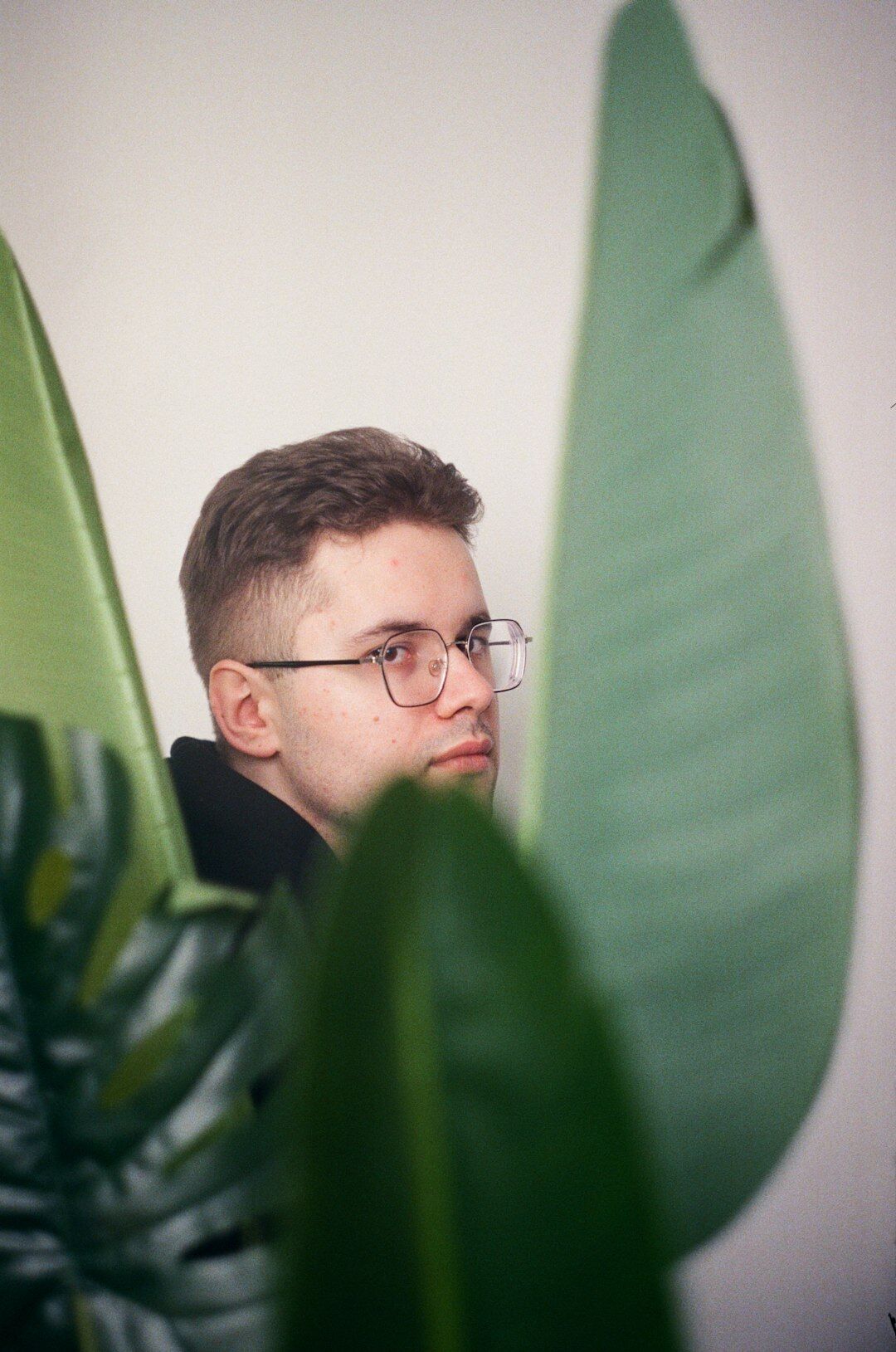 Studio portrait of a European man editor wearing glasses